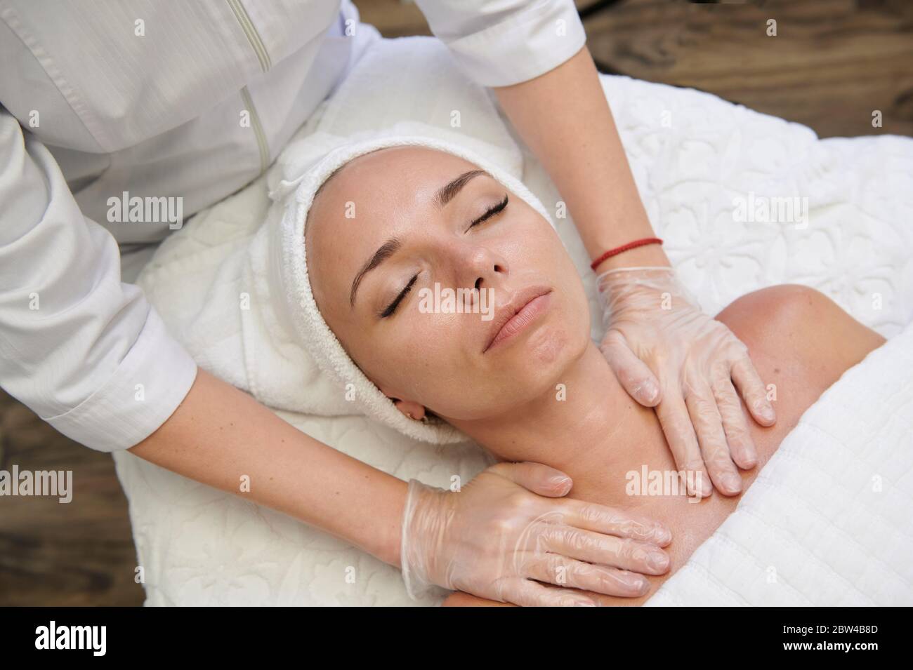 Female getting in spa facial treatment alternative medicine Stock Photo