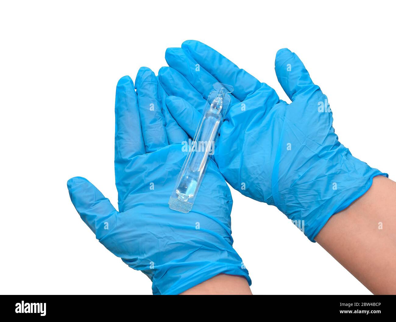 Bottle of injections in the arm, doctor's hands in medical gloves. Liquid medicine or vaccine for treating viral diseases in a laboratory or hospital. Stock Photo