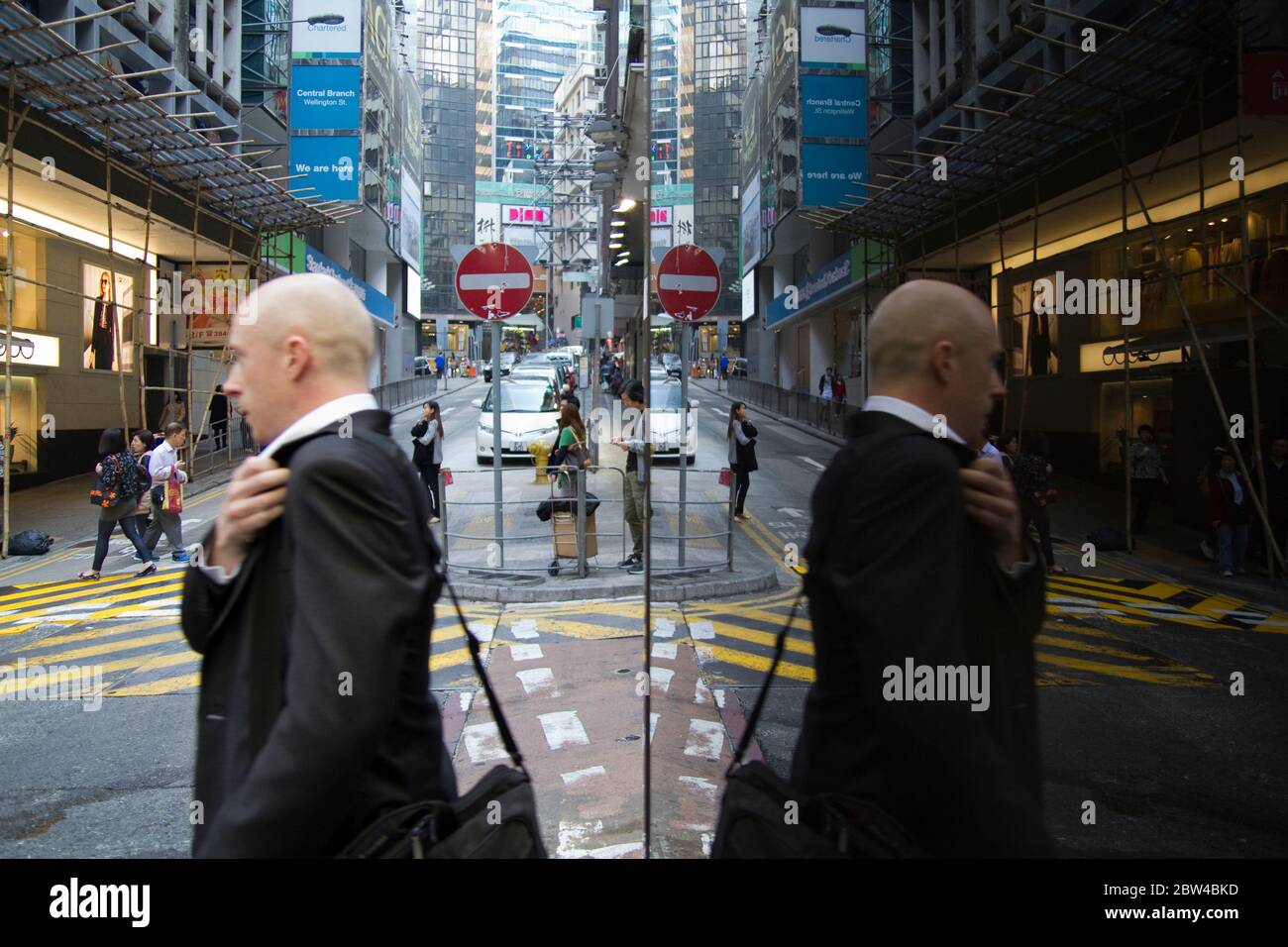 Shaved head Business man on Hong Kong street Stock Photo