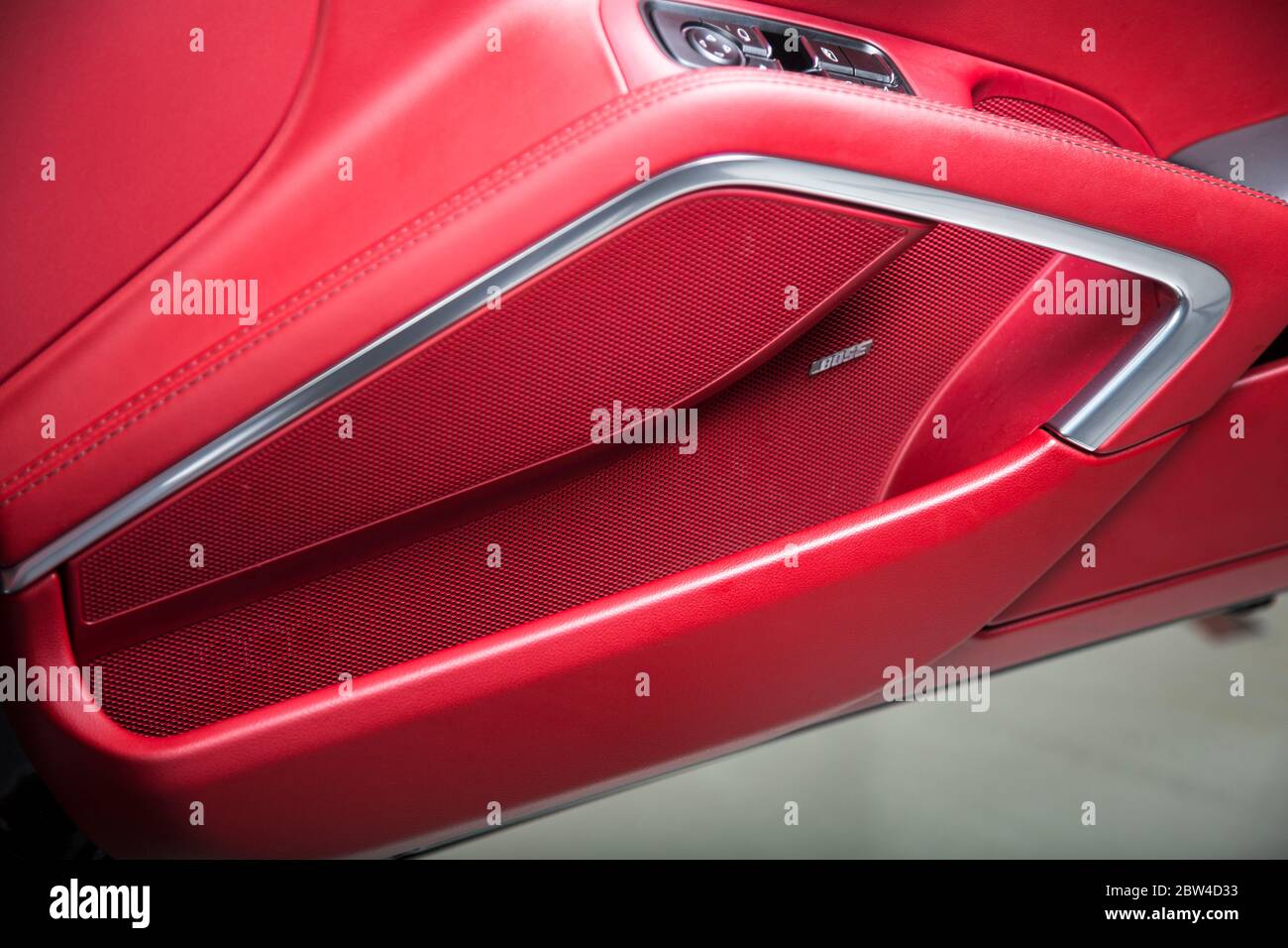 Bose speaker on red leather car door Stock Photo Alamy
