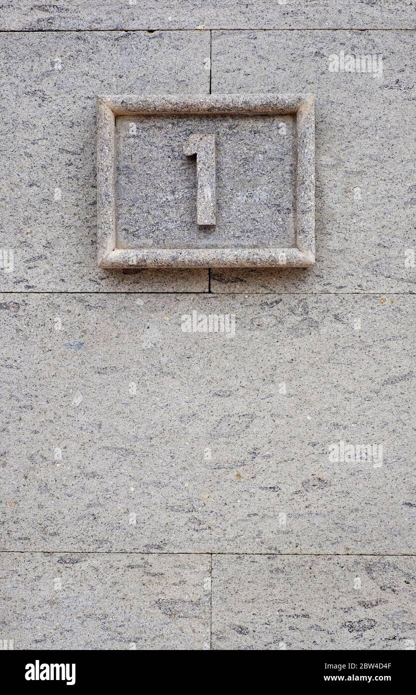 One, 1, digit symbol on vertical stone background. Stock Photo