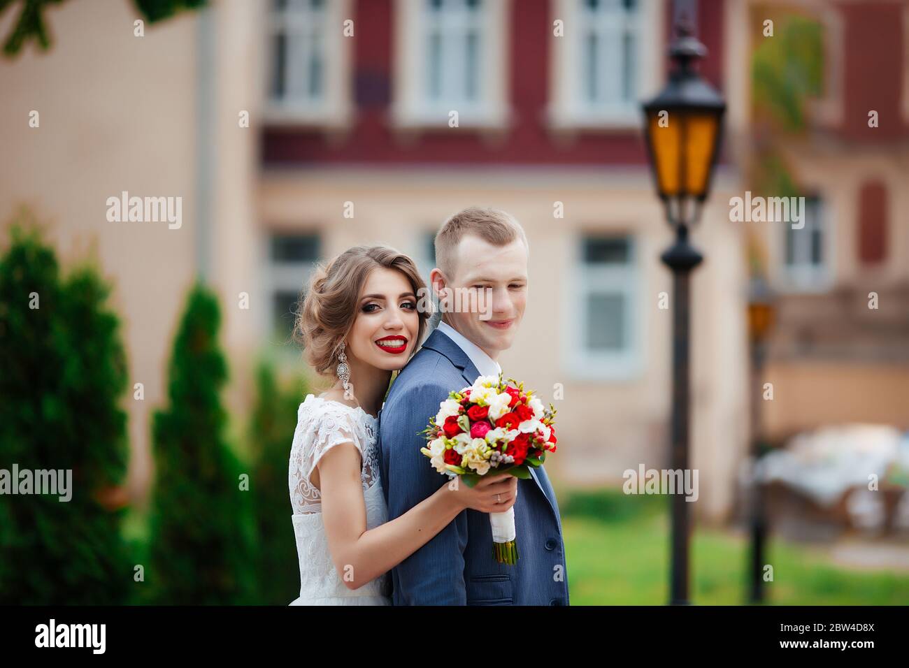 Fabulous young wedding couple posing in the park on the sunny day Stock ...