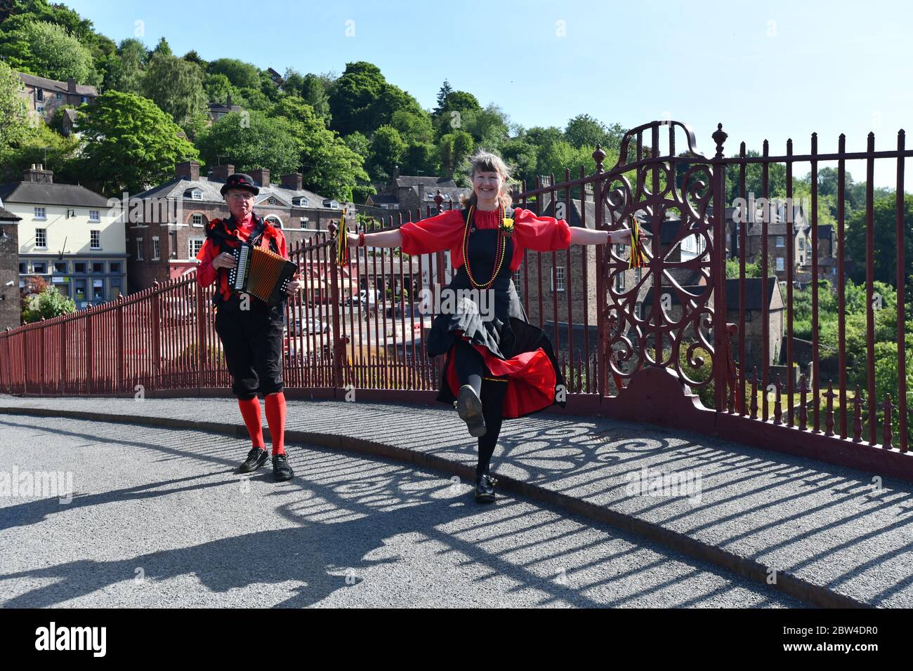 Ironbridge, Shropshire, Uk May 29th 2020 Ironbridge Morris dancers Pat and John Parnell came out of isolation today to dance on the world famous Iron Bridge near their home.The couple are members The Ironmen & Severn Gilders dance group and are taking part in a 'virtual dance event' and mass video of North West Morris called 'The Celebration' as part of a Morris participation event that can be done under lockdown and social distancing. Stock Photo