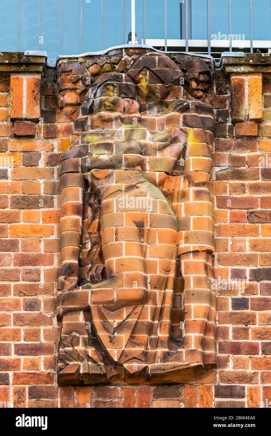 A cut brick relief sculpture representing 'Love' on the north wall of the RSC Shakespeare Theatre in Stratford Upon Avon, England Stock Photo