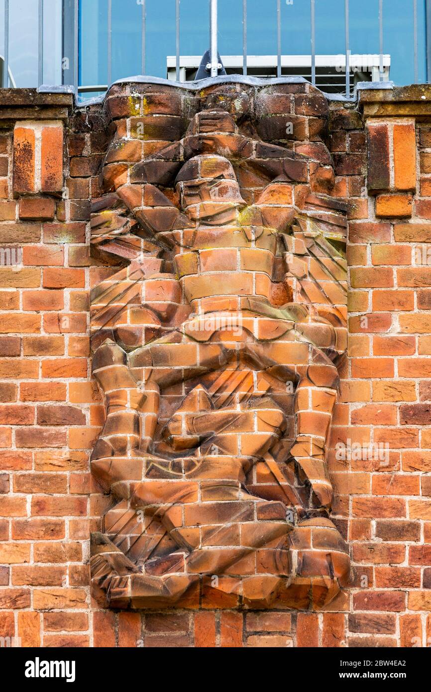 A cut brick relief sculpture representing 'Martial Ardour' on the north wall of the RSC Shakespeare Theatre in Stratford Upon Avon, England Stock Photo
