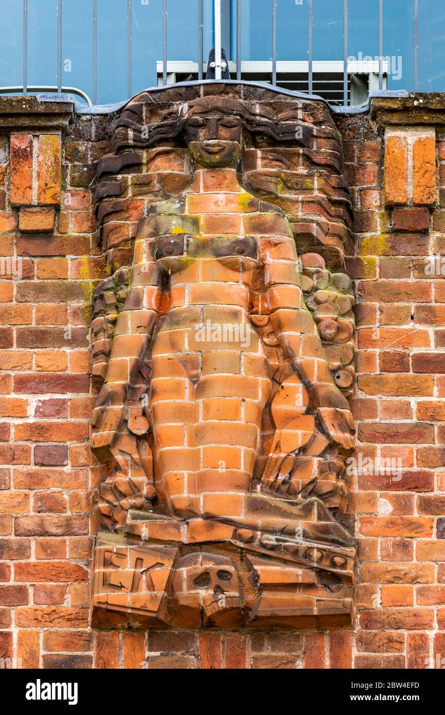 A brick relief sculpture representing 'Life Triumphing over Death' on the north wall of the RSC Shakespeare Theatre in Stratford Upon Avon, England Stock Photo