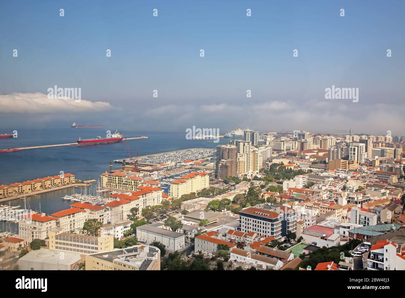 View from the Rock of the city below, the commercial port & also the coast of Africa in the far distance, Gibraltar. Stock Photo