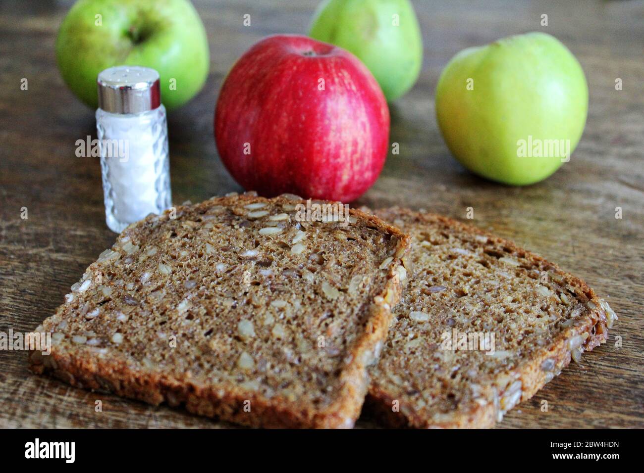 Bread with corn and salt and apples on a table Stock Photo