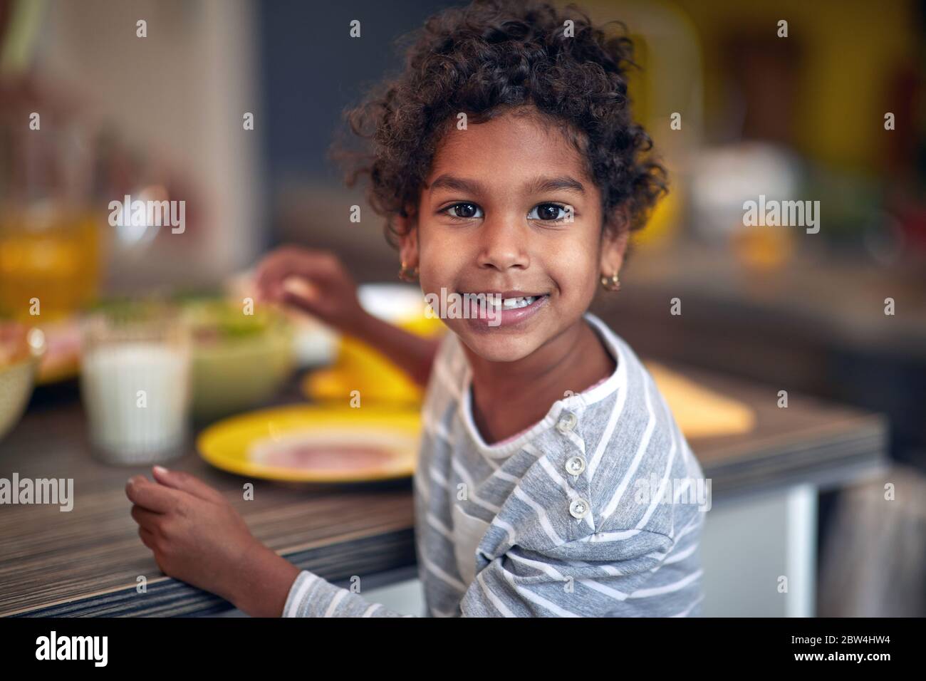 Afro American  cute girl having breakfast at morning. Stock Photo