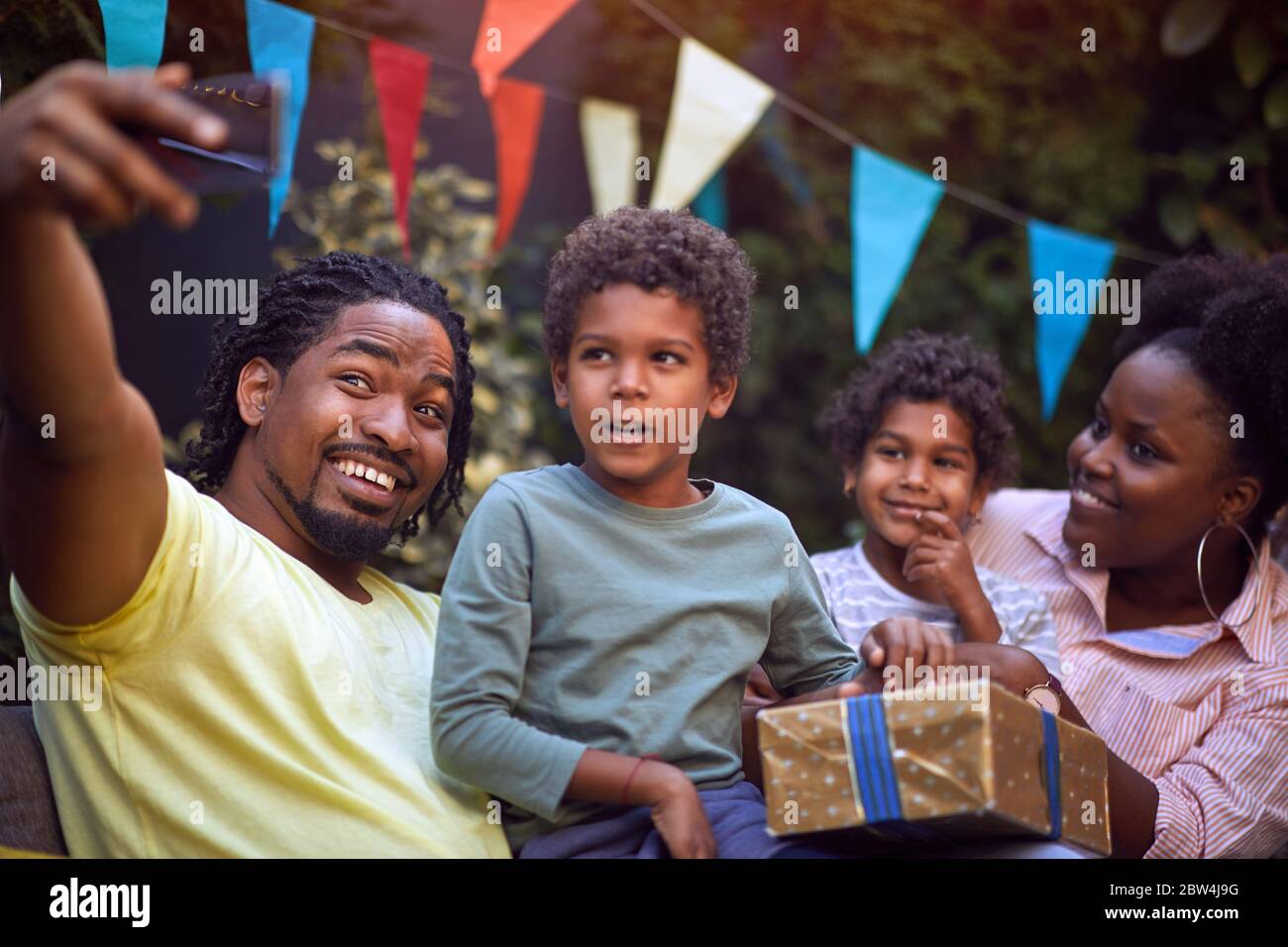 Happy young afro-american family with childs at birthday party have fun and making selfie. Stock Photo