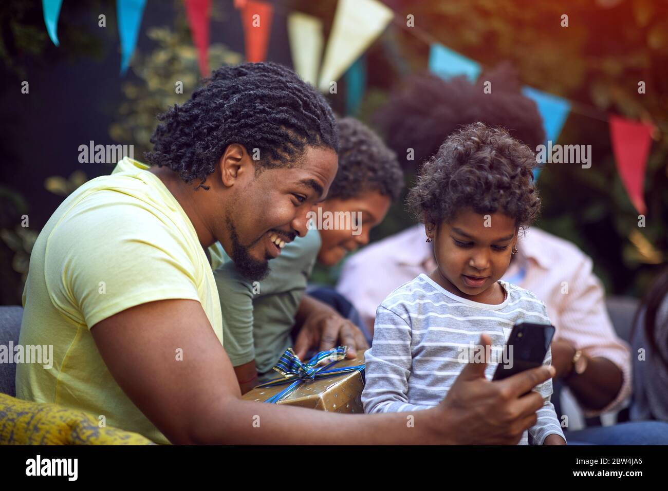 young afro-american family  with childs at birthday party have fun and making selfie. Stock Photo