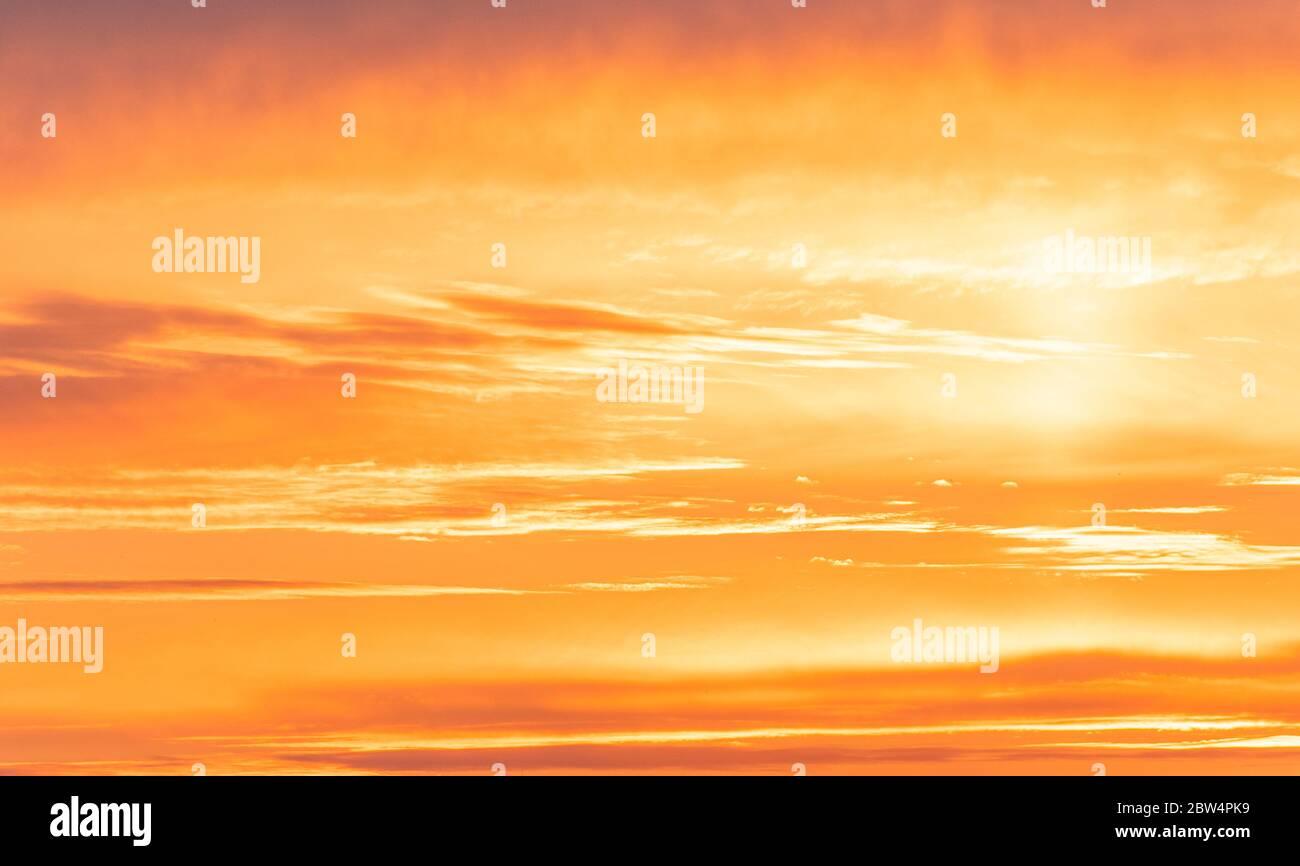 Amazing sky during golden sunset, bright orange sky with sunlight Stock Photo