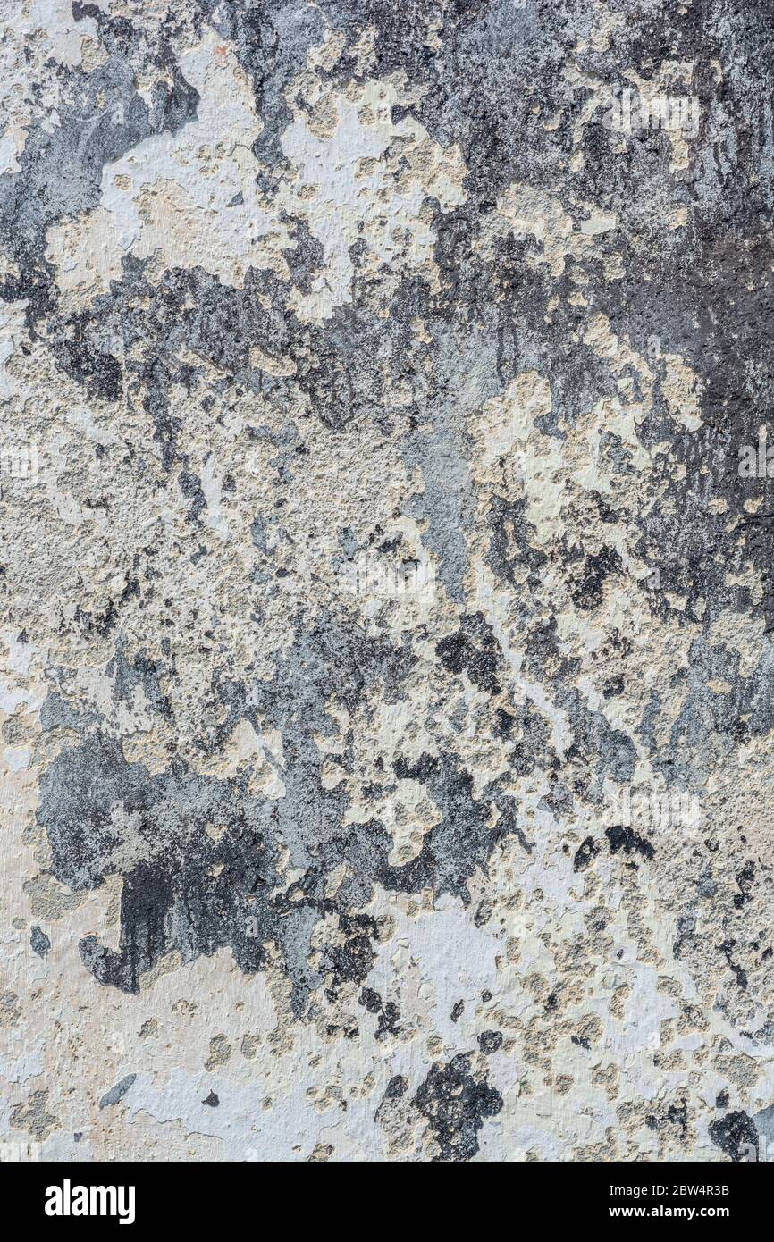 Rough and dirty paint texture on exterior house wall prepared for new paint covering. Old paint texture, blank canvas metaphor, flaking wall paint. Stock Photo