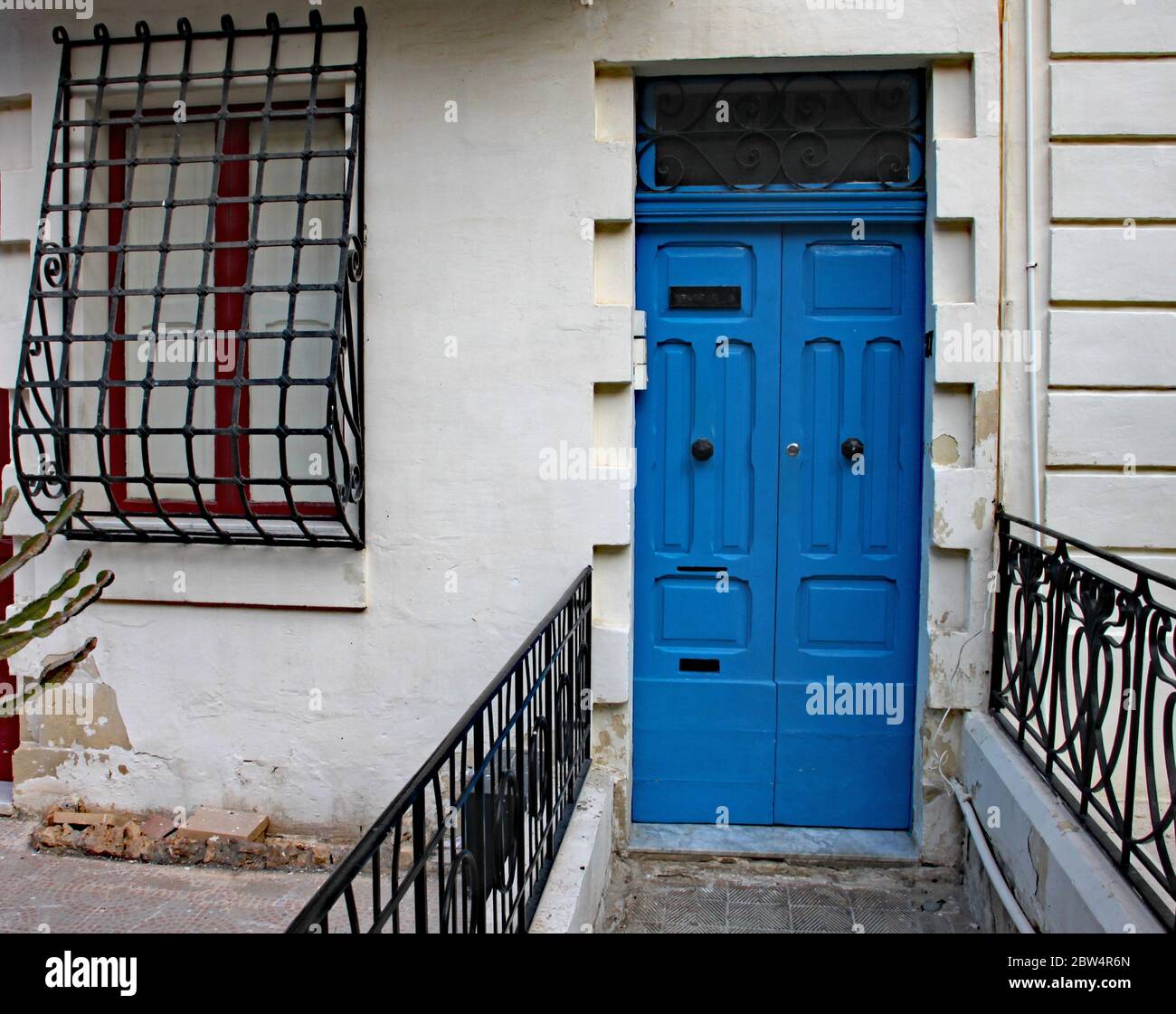 Old blue front door and barred window on a house in Sliema in Malta ...