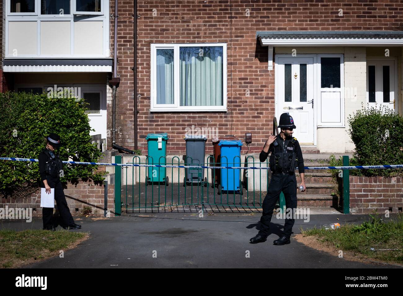 Manchester, UK. 29th May, 2020. Police officers remain outside the crime scene on Greenwood Road. Credit: Andy Barton/Alamy Live News Stock Photo