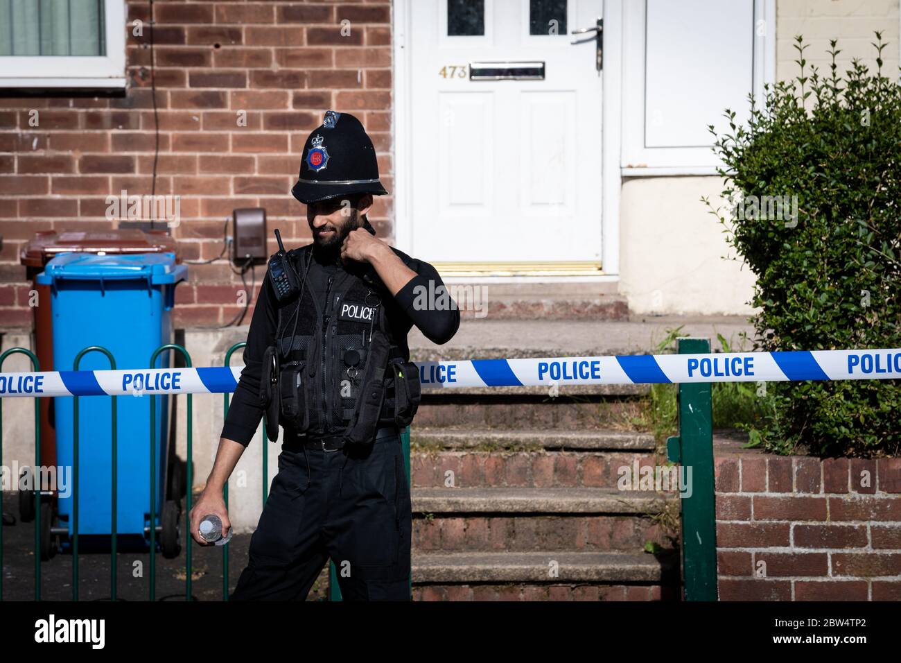Manchester, UK. 29th May, 2020. A Police officer remains outside the crime scene on Greenwood Road. Credit: Andy Barton/Alamy Live News Stock Photo