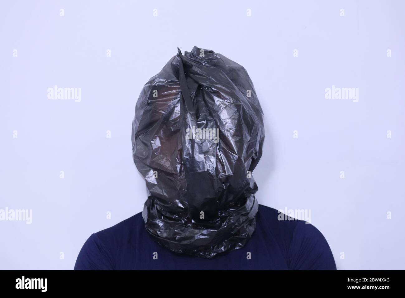 black plastic bag wraps around a human head Stock Photo