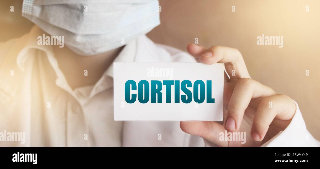 Doctor's Hand with white card with Cortisol word. Immune System Healthcare medical Concept Stock Photo