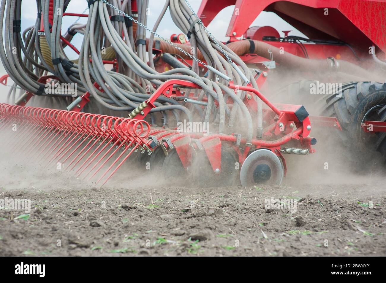 Tedder rake work in field with dust Stock Photo - Alamy