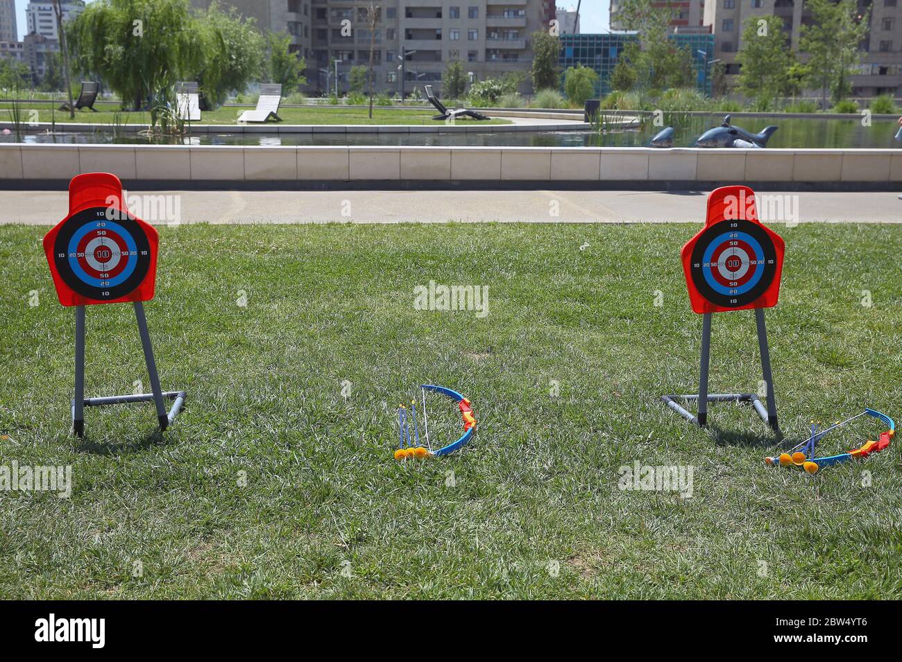 Children play . Kids Archery Bow Suction Arrow Target Board Set Outdoor