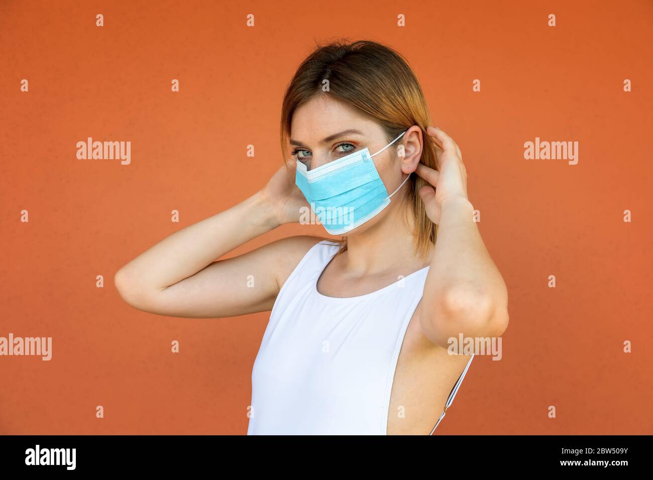 Young girl shows how to wear the protective mask to protect herself