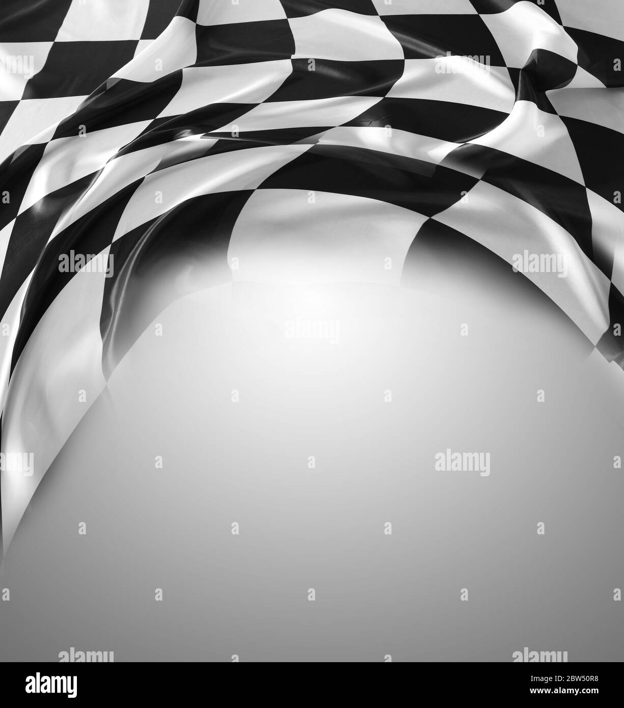 Checkered black and white flag on grey background. Copy space Stock