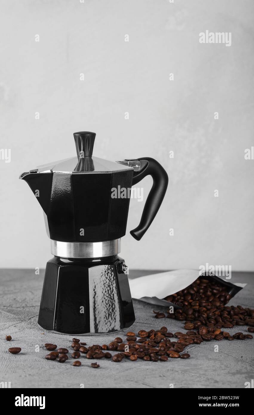 Black geyser coffee maker on a stone table. Stock Photo
