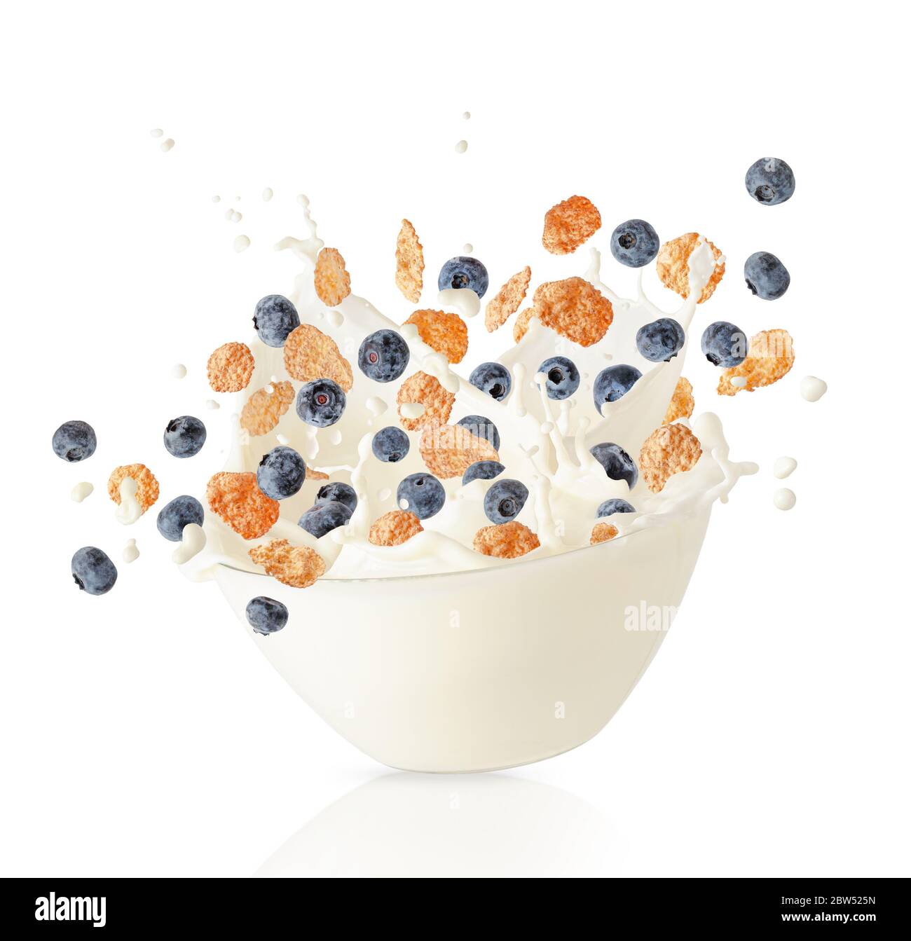 Cereal corn flakes and blueberries falling into bowl with milk splash. Healthy breakfast. Isolated on white Stock Photo