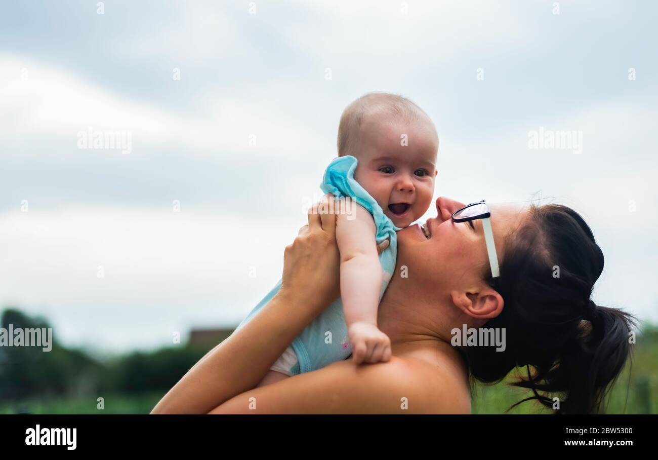 Shot of loving mother holding baby up outdoors Stock Photo