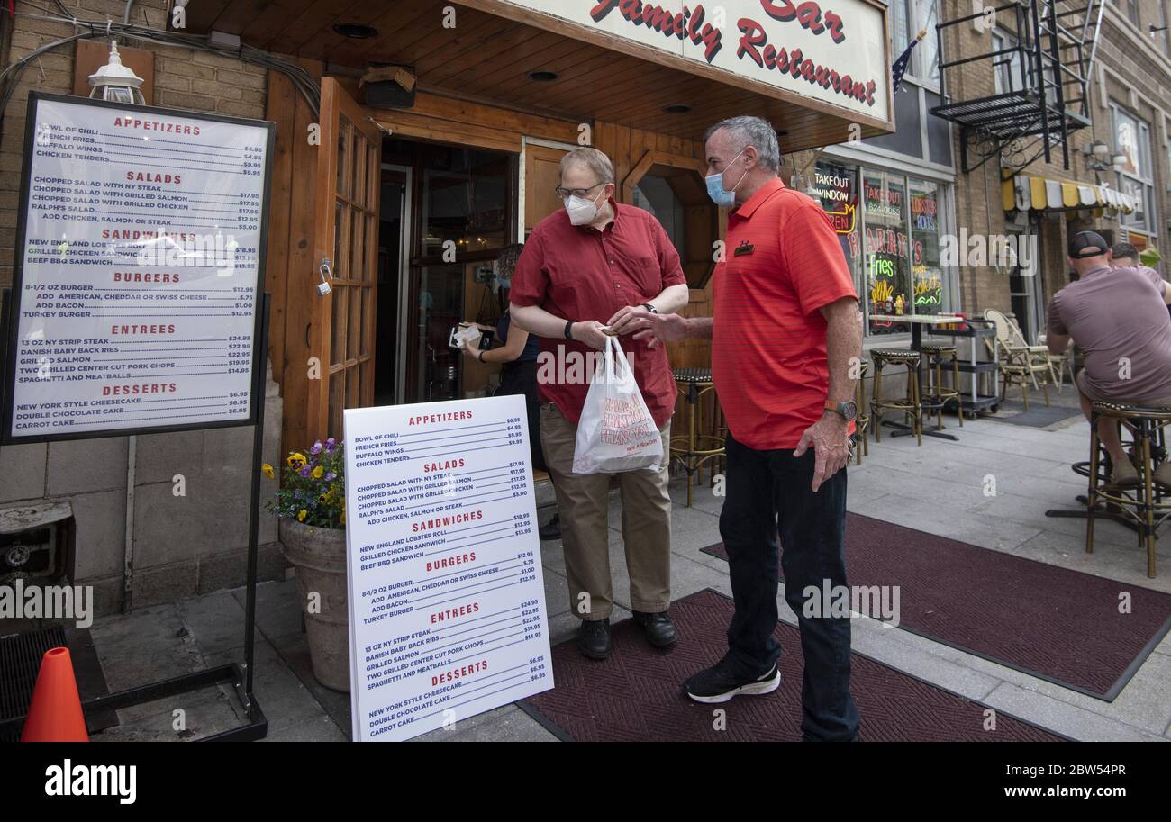 Washington, United States. 29th May, 2020. Harry's Bar and Restaurant owner John Boyle talks to a take-out customer as he opens for business as phase one starts in downtown Washington, DC a few blocks from the White House on Friday, May 29, 2020. The nation's capital is allowing restaurants to serve customers outside only with other restrictions after being closed for more than two month due to Covid-19. It is expected that 30 to 40 percent of DC restaurants will not reopen due to the pandemic. Photo by Pat Benic/UPI Credit: UPI/Alamy Live News Stock Photo