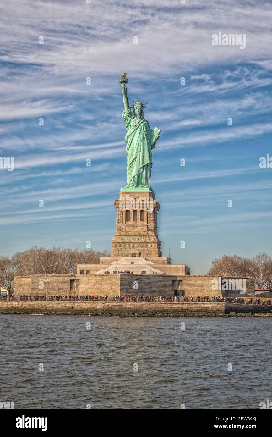 The Statue of Liberty in New York City USA daylight view with clouds in sky Stock Photo