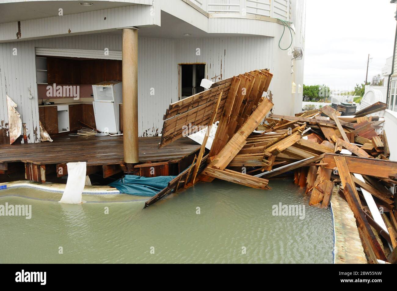 House is devastated by a hurricane that forced the ocean through the house. Deck is ripped up as well as the interior destroyed. Stock Photo