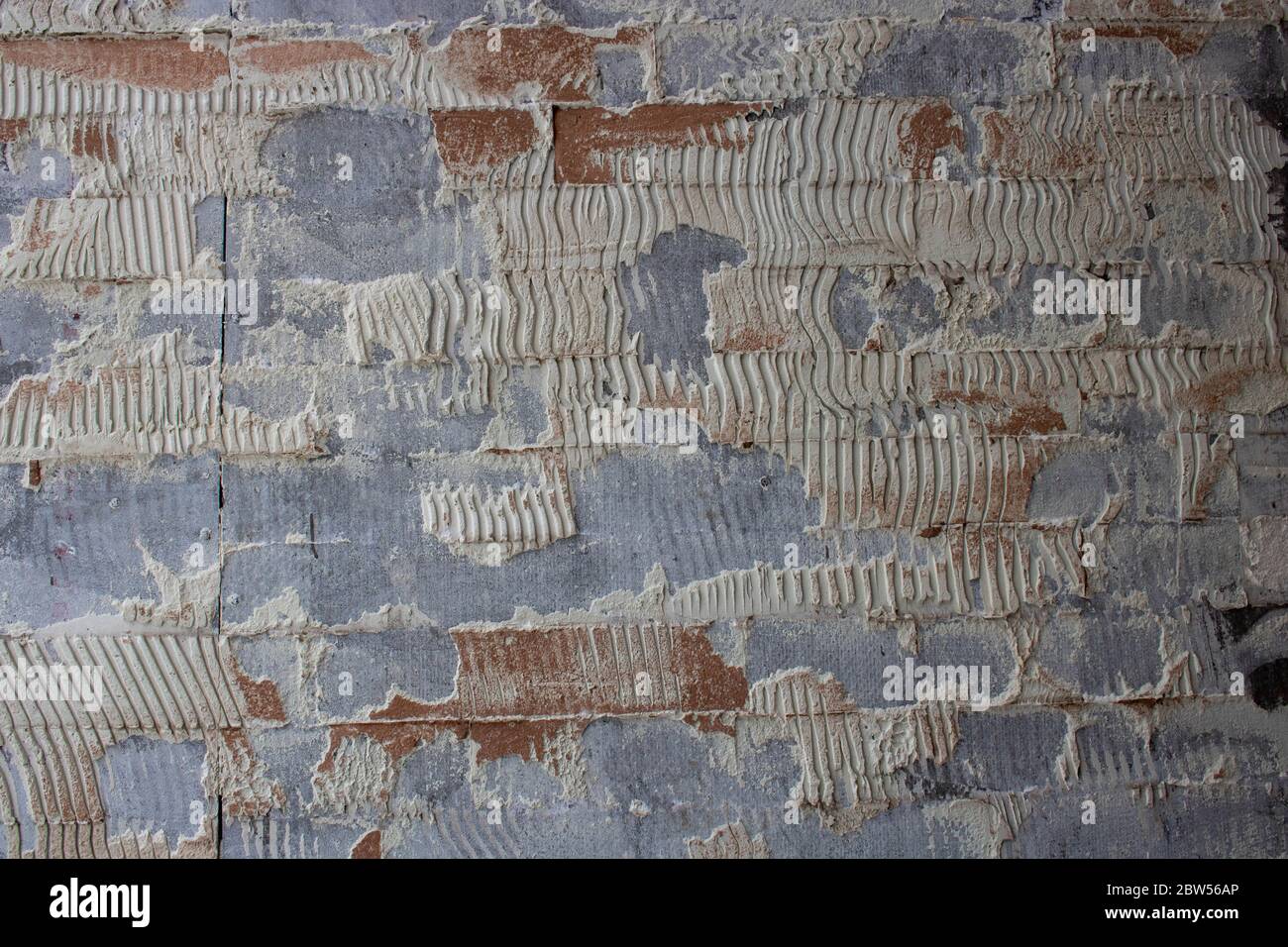 old tile glue or cement . broken wall tiles.wall without tiles Stock