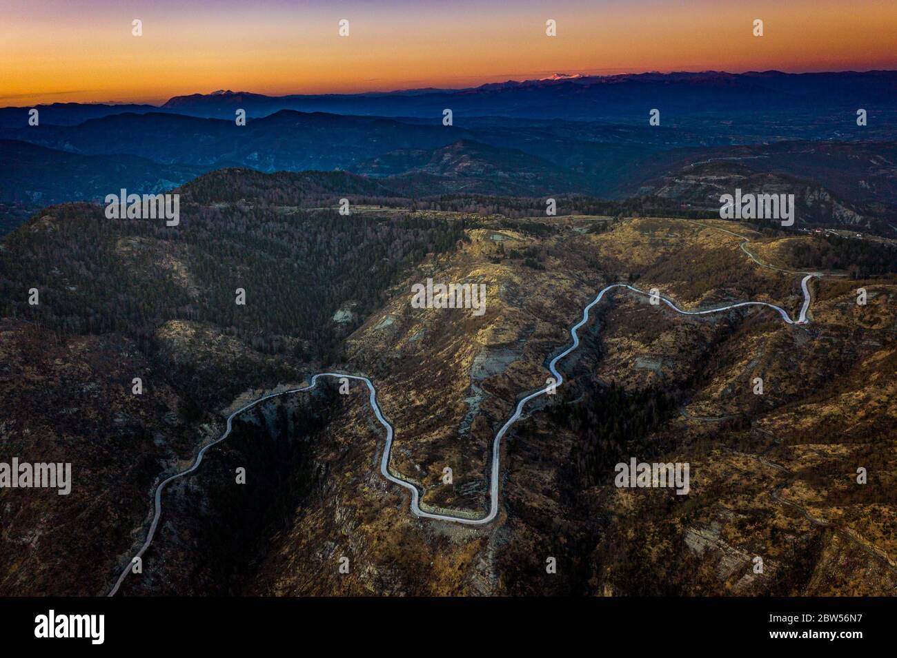 Aerial view the serpentine road with a lot of zigzags in mountains near