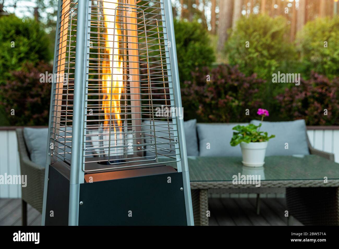 outdoor gas pyramid heater working on terrace Stock Photo