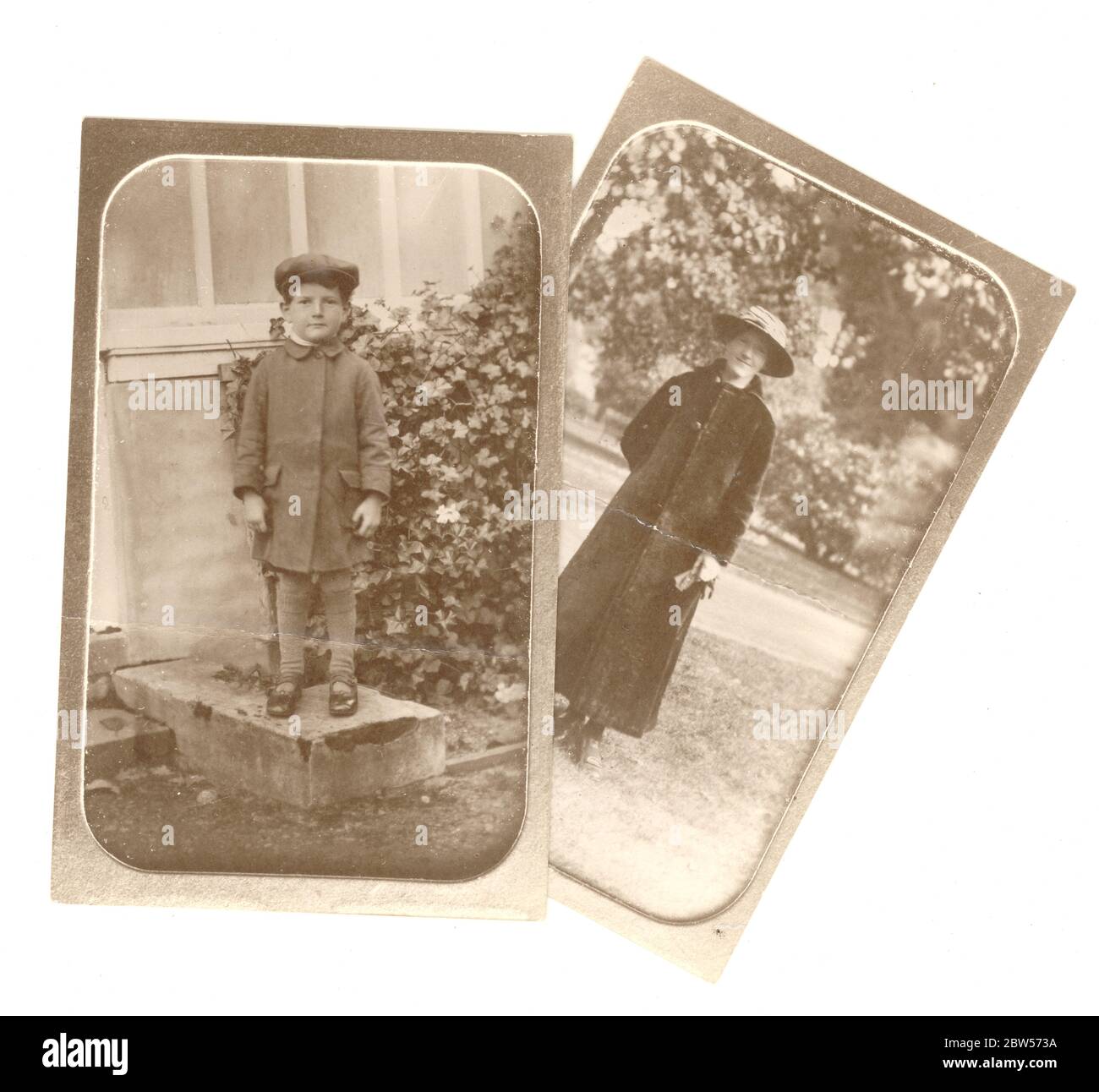 Early 1900's copy of an Edwardian photo taken from a photograph album, depicting a woman in a long coat and a small boy wearing a cap, standing outdoors, original photo is circa 1910, U.K. Stock Photo
