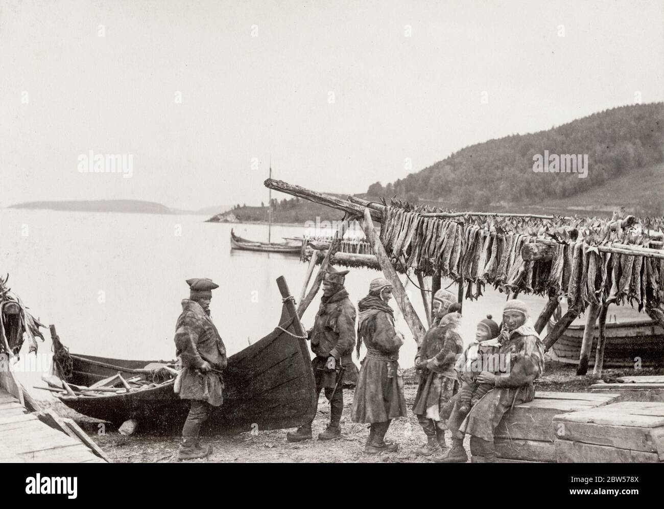Vintage 19th century photograph - Tromso, Norway, fishermen and family with drying fish. Stock Photo