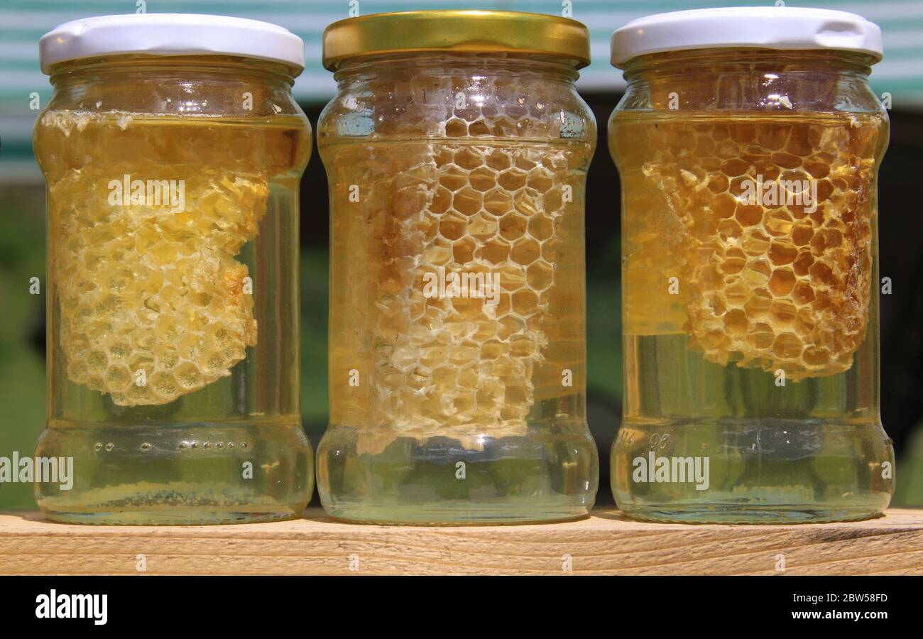 Three honey jars for sale. Honey is a sweet, viscous food