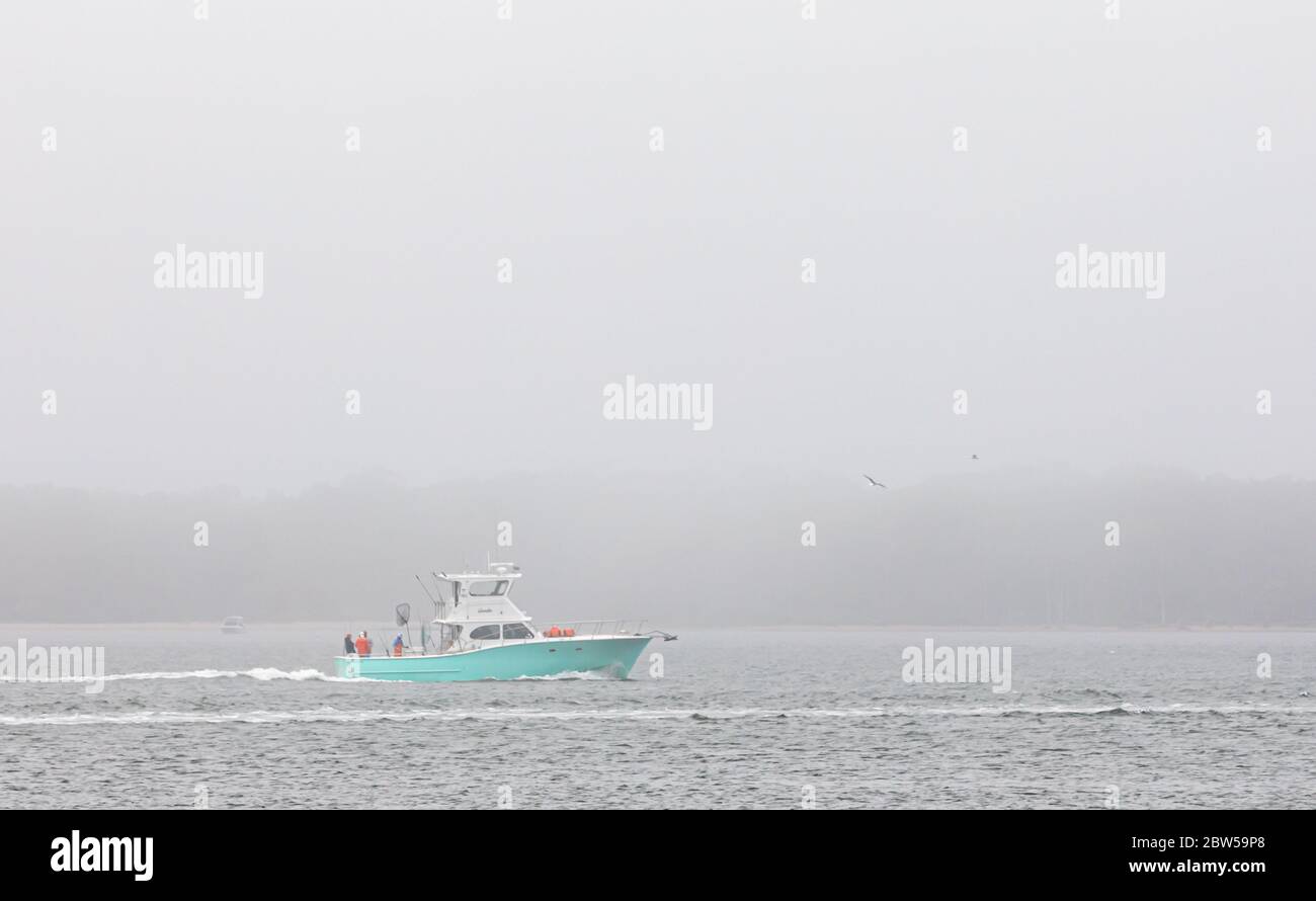 fishing boat on a foggy summer day near Greenport, NY Stock Photo