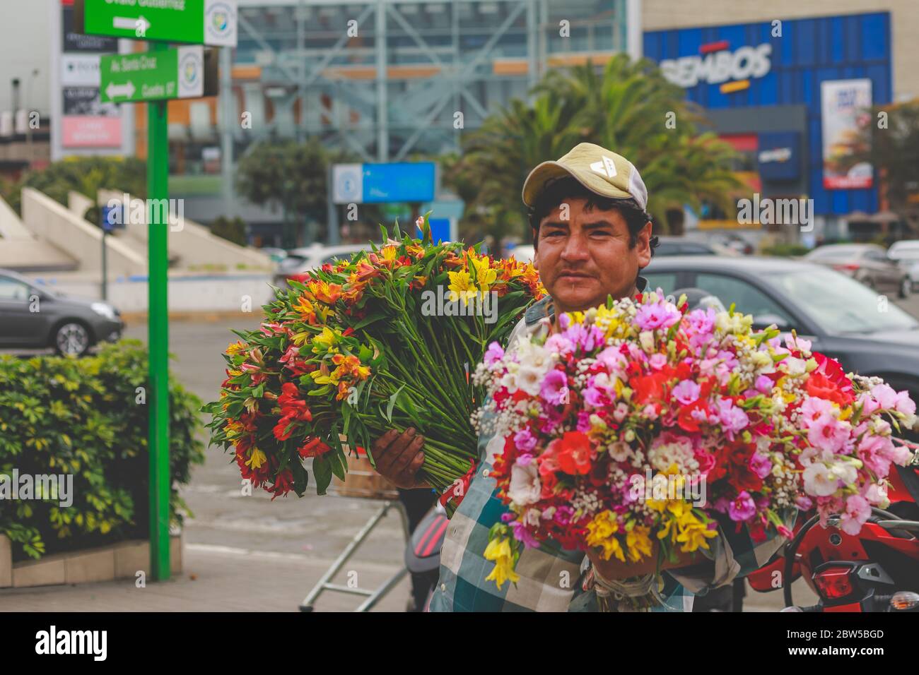 Peruvian man selling flowers on the street Stock Photo