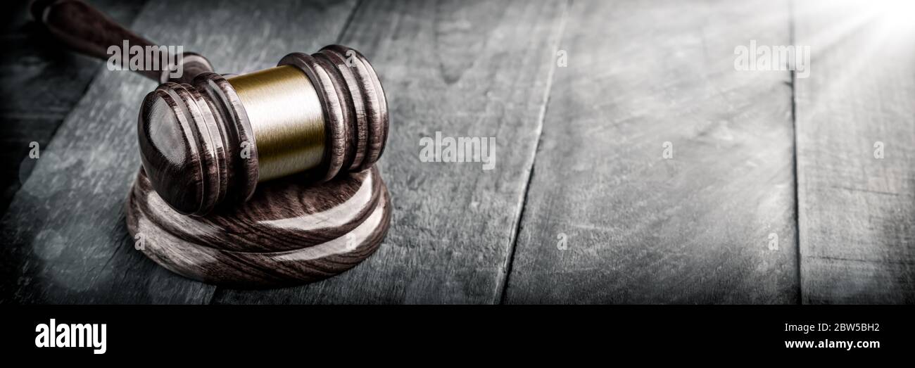 Gavel And Block On Wooden Desk With Sunlight - Law And Justice / Auction Concept Stock Photo