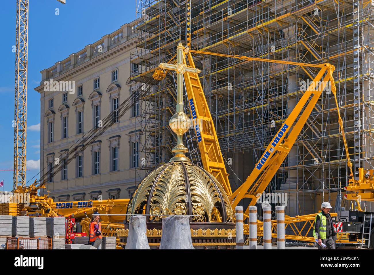 Berlin, Germany -  May 29, 2020: Golden Cupola waiting to be put on the dome of the  Berlin City Palace (German: Berliner Stadtschloss). Stock Photo