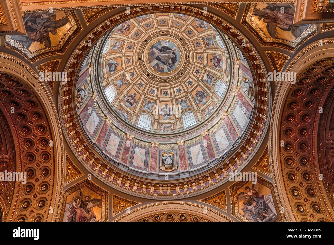 Upward view of gilded golden dome cupola inside St. Stephen's Basilica