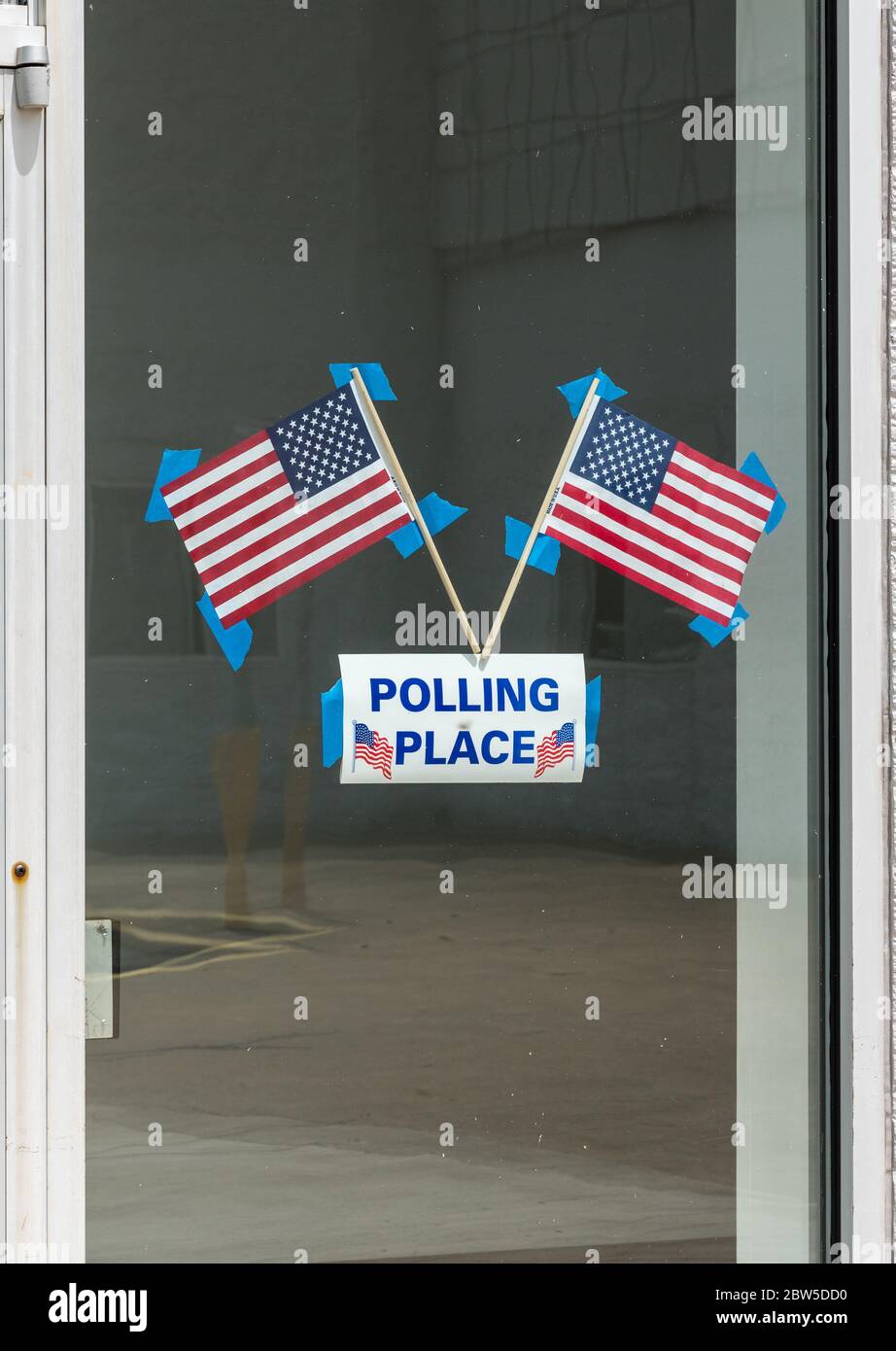 USA flags stuck to window of Polling place for early voting in the USA elections Stock Photo