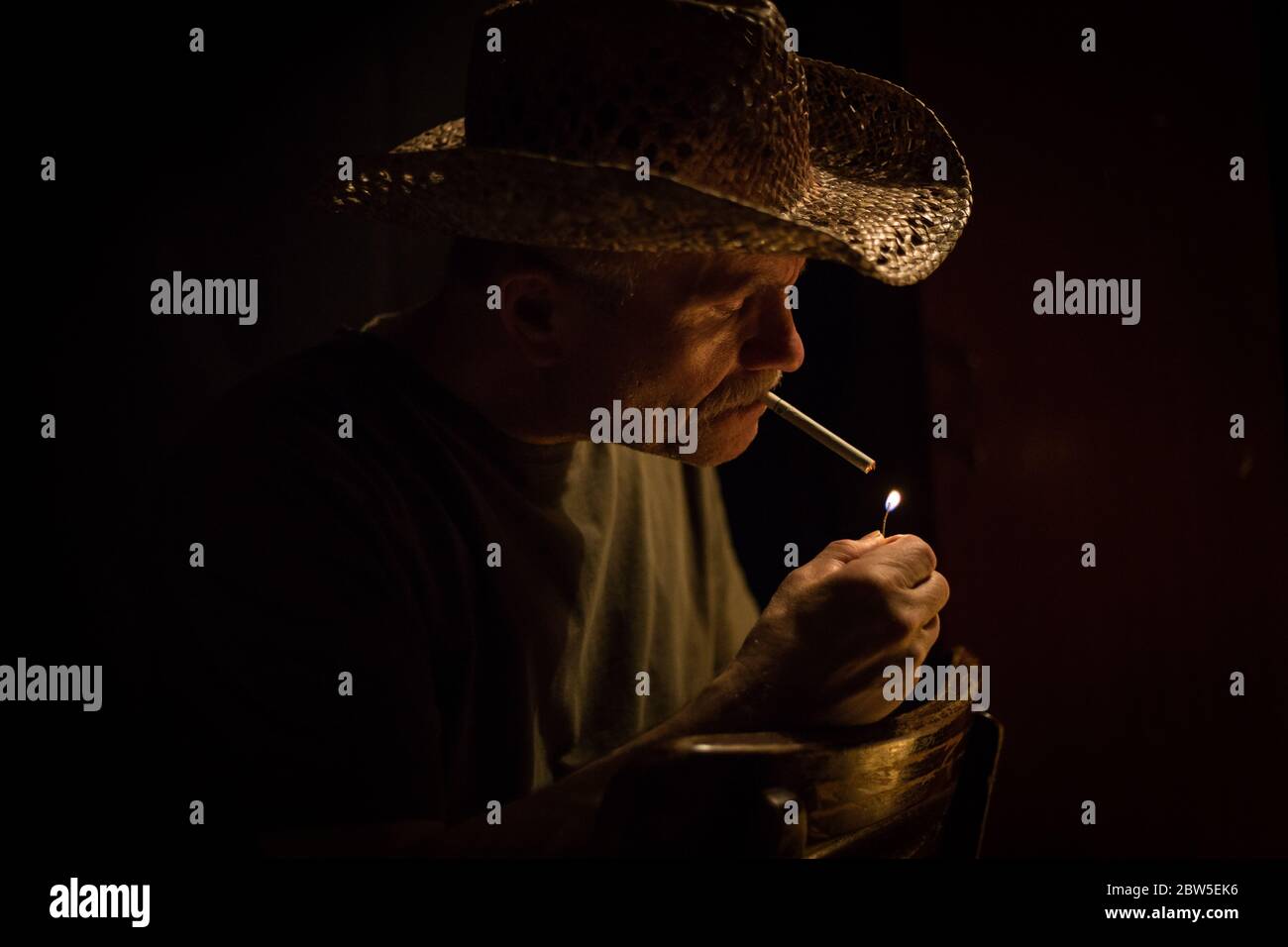 Cowboy lighting a cigarette hi-res stock photography and images