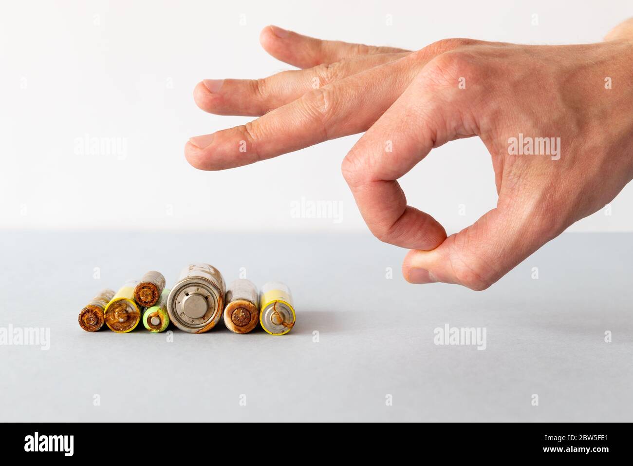 Close up of man hand gets rid of spent used rechargeable battery with