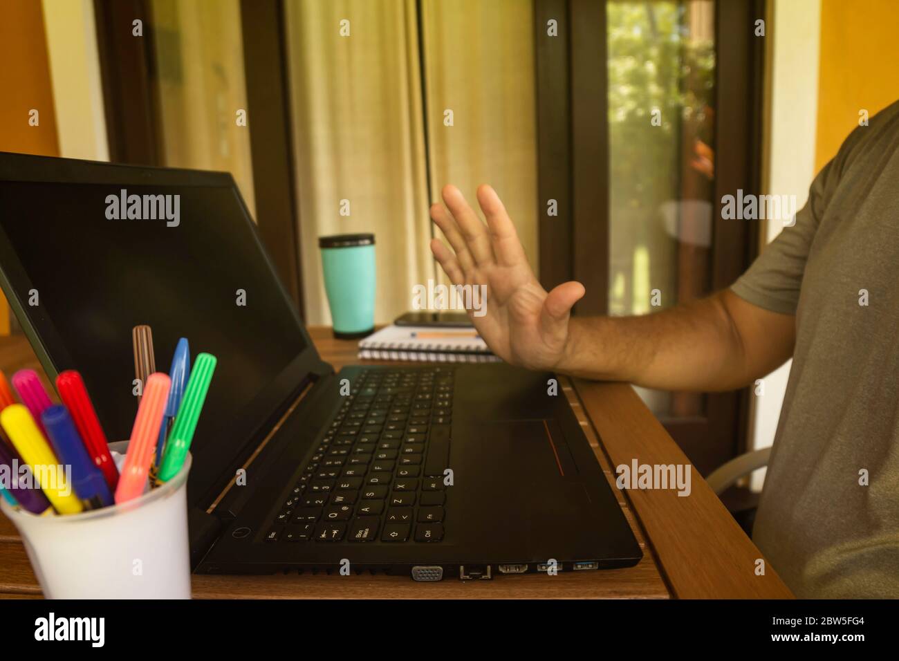 Man doing computer work from home during quarantine. Social isolation of office workers. Pandemic teleworking concept Stock Photo