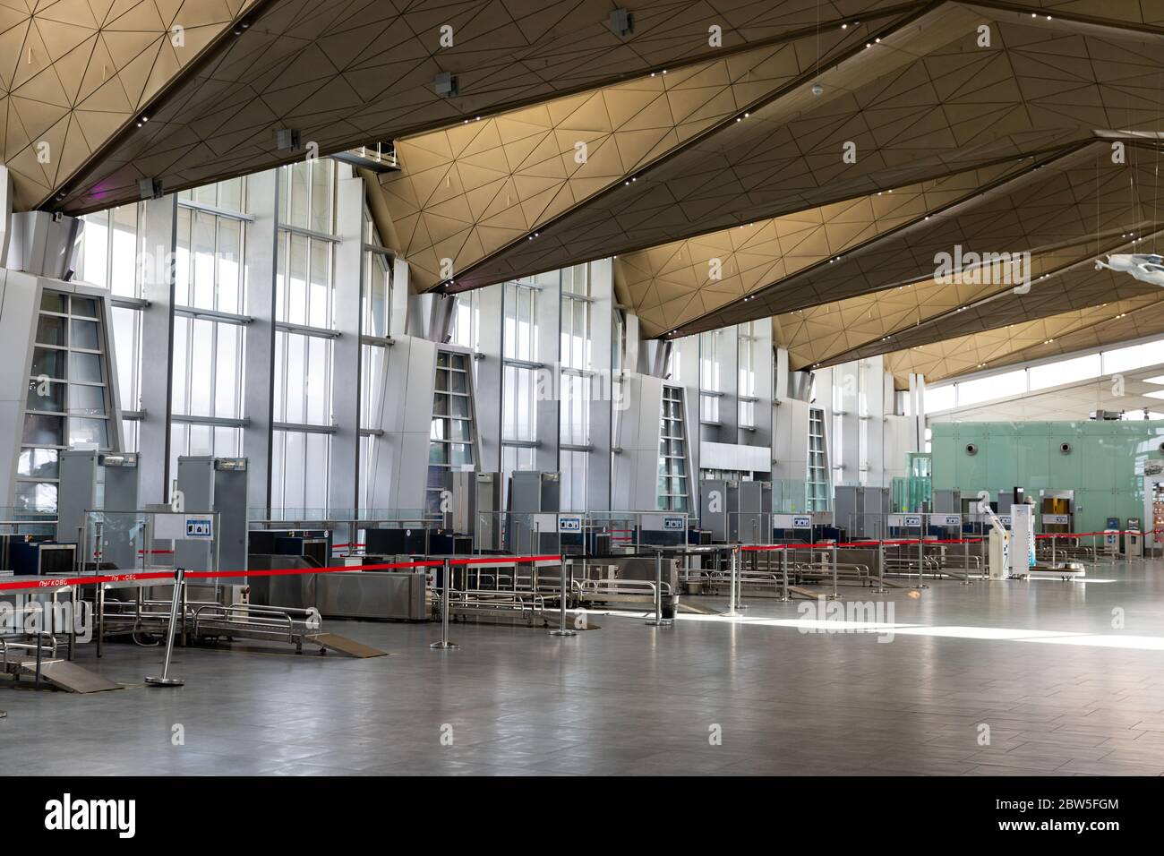St. Petersburg, Russia – May 18, 2020.Empty Airport. Row of x-ray machine for screening passenger luggage with frame metal detector tables for inspect Stock Photo