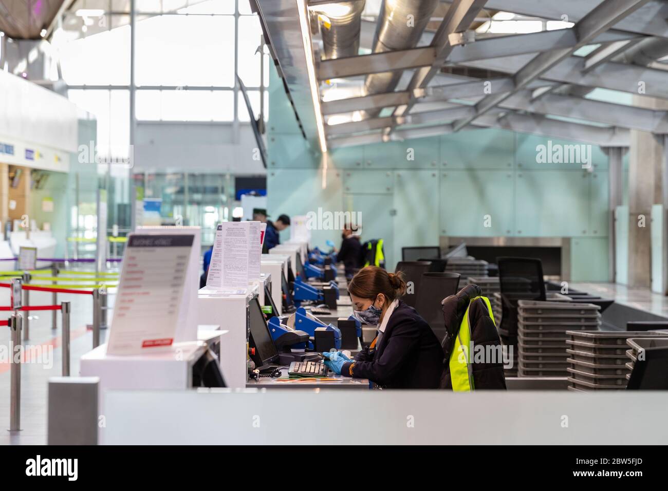 St. Petersburg, Russia – May 8, 2020. Registration check-in counters at almost empty Pulkovo airport due to coronavirus pandemic.Bored staff woman in Stock Photo