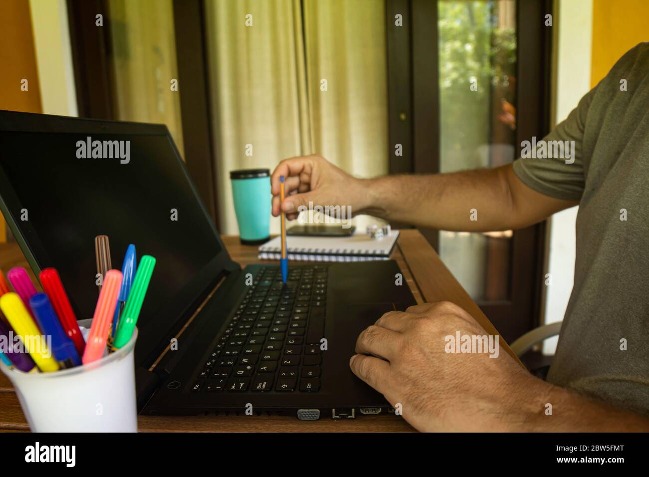 Man doing computer work from home during quarantine. Social isolation